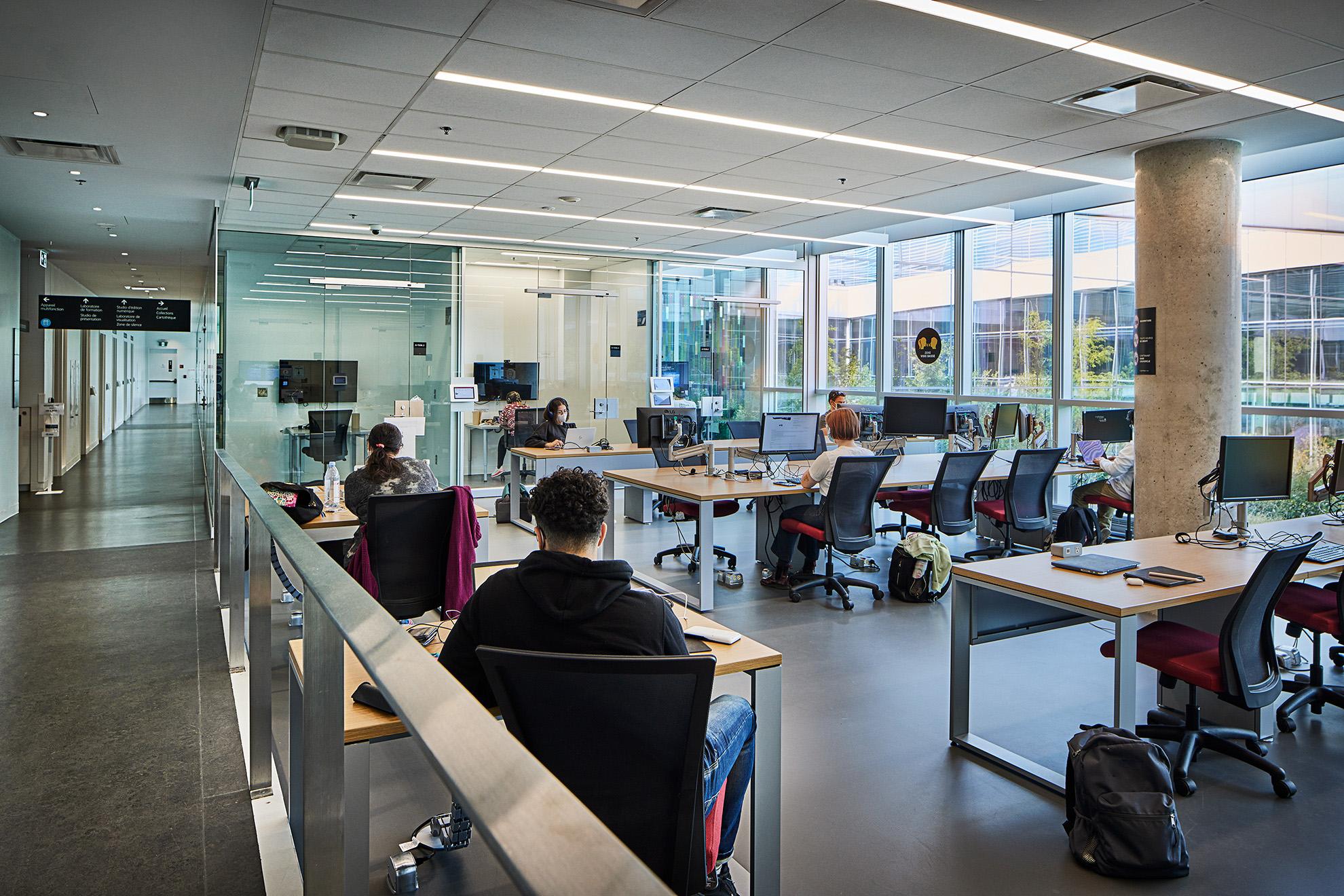 Students studying in a bright university learning space
